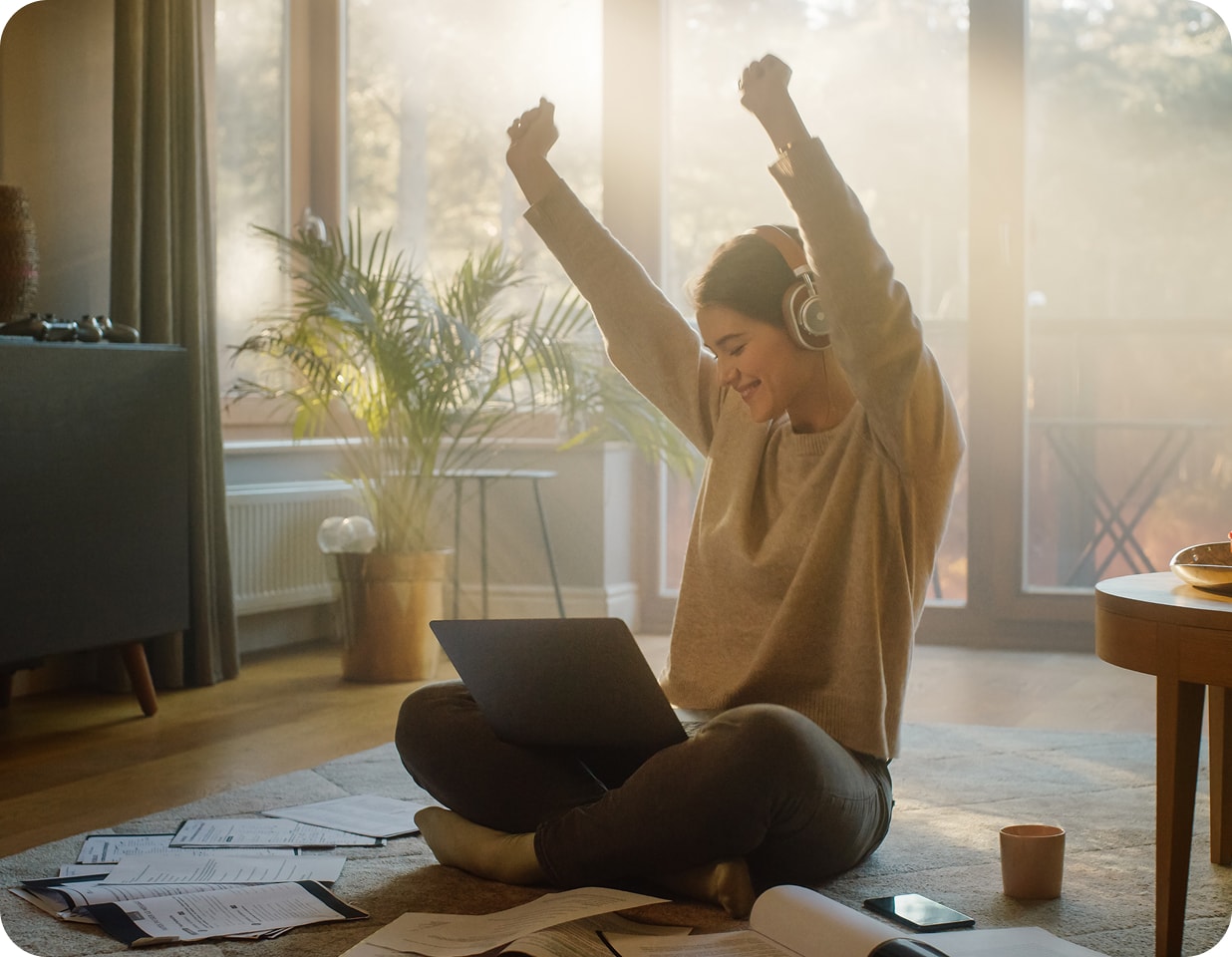 A seller celebrating while reviewing their listing on a laptop